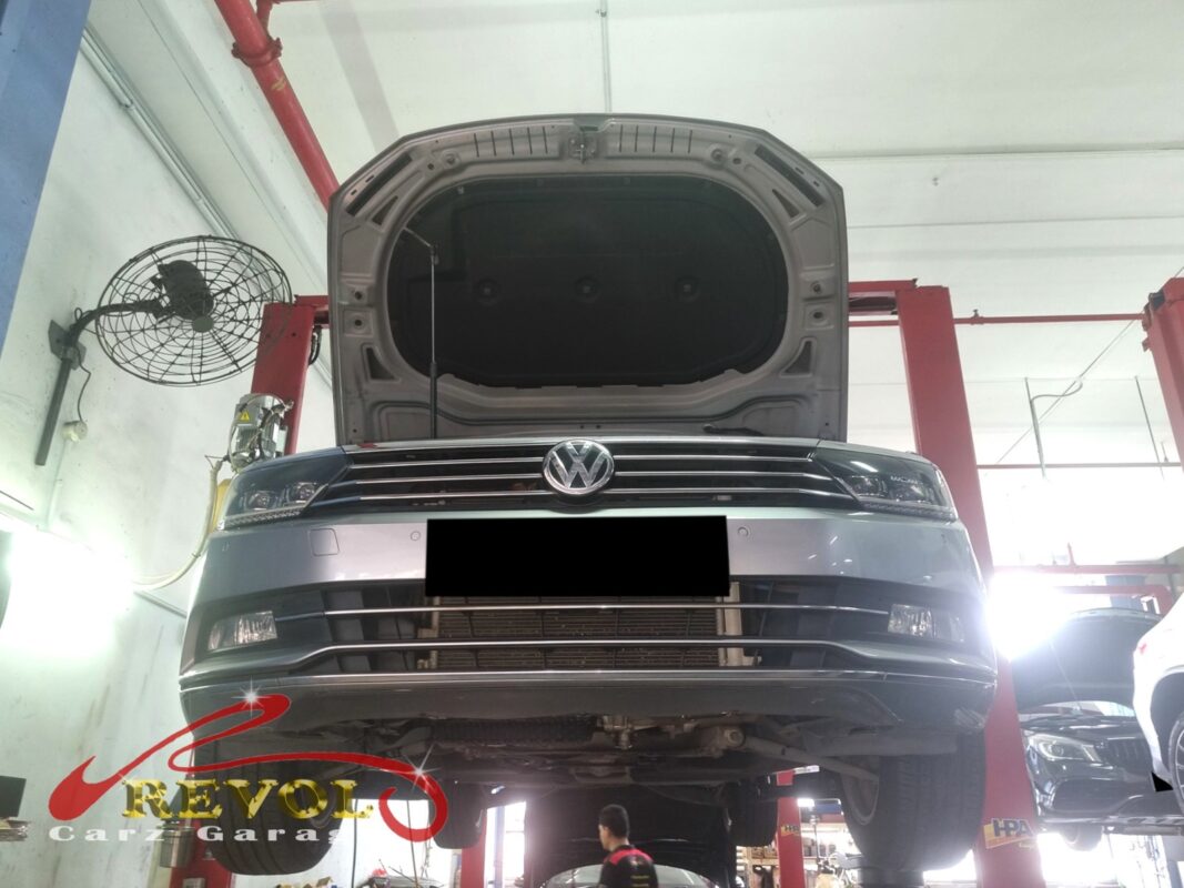 The Passat up on the two-post lift, bonnet open, in for the slow coolant loss.