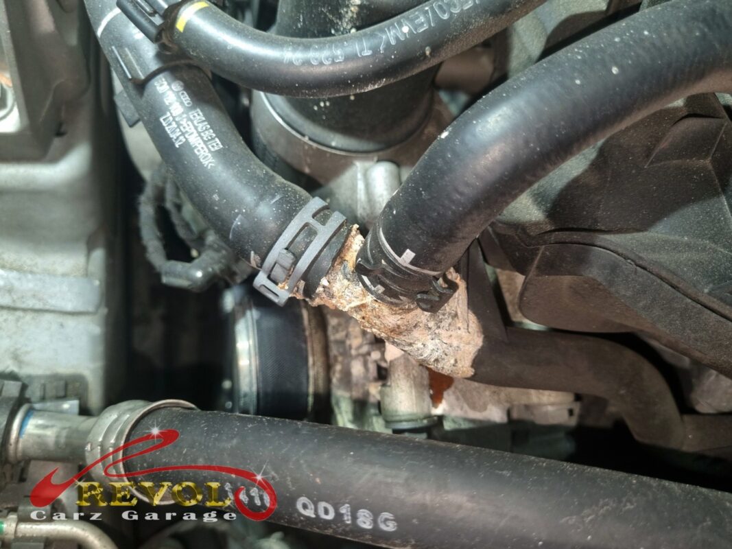 The corroded coolant hose connector that was bleeding pressure, crusted and crumbling.