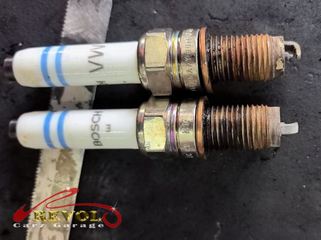 Two of the old plugs out, the threads rusted and the electrodes worn down.