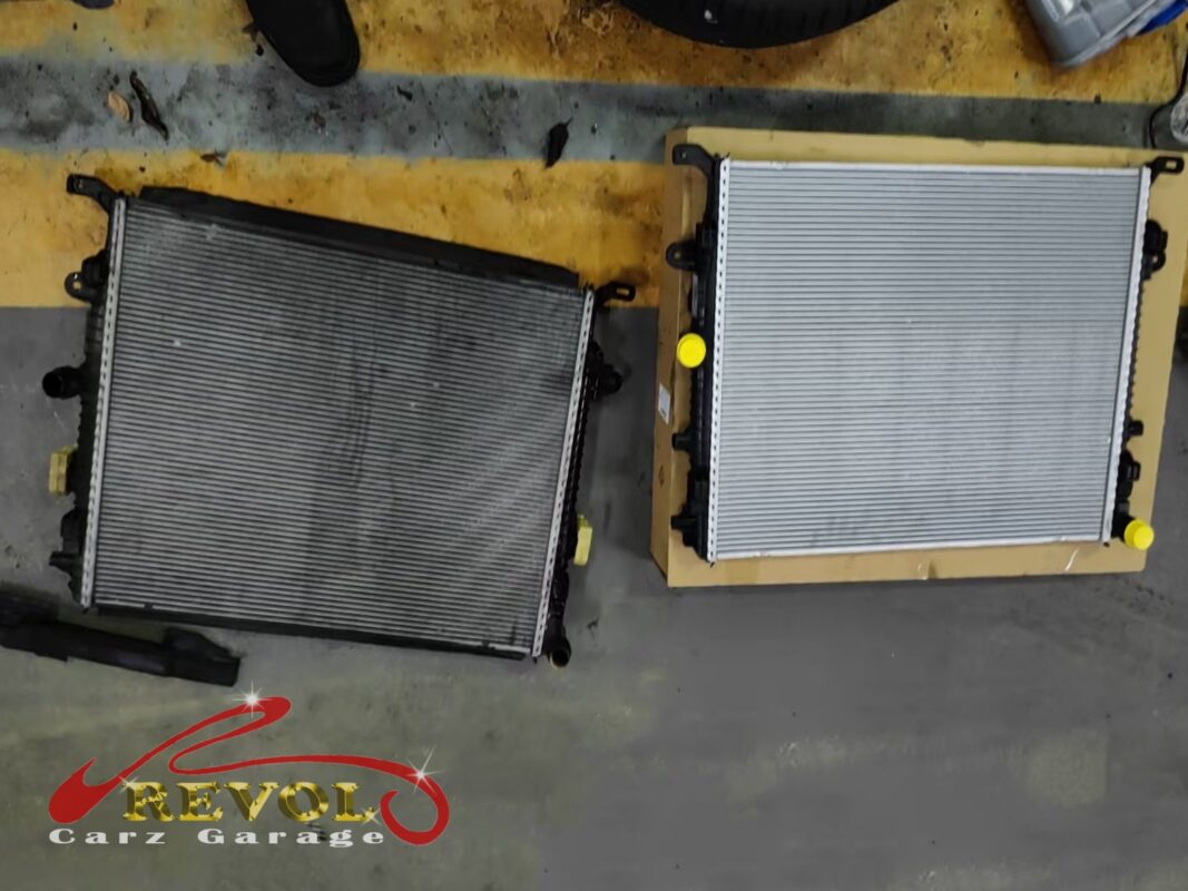 The old radiator (left, grimed over) beside the new VAG-spec replacement (right), still boxed.