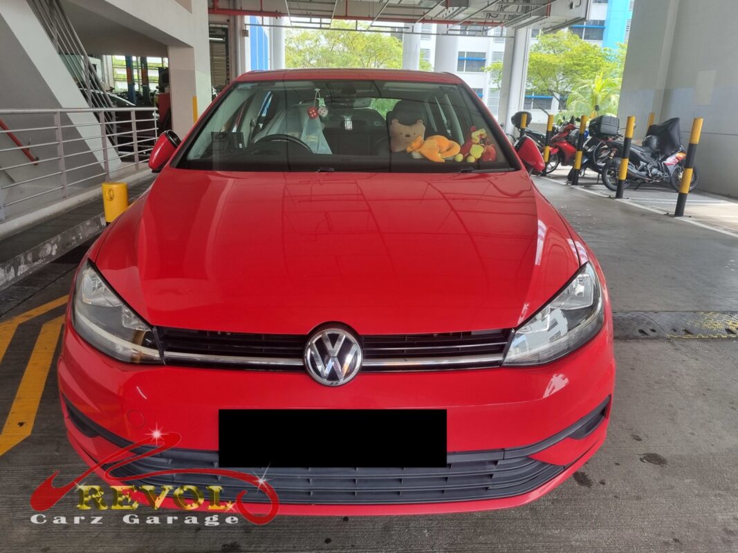 Volkswagen Golf with the front of the engine open for timing belt set replacement.