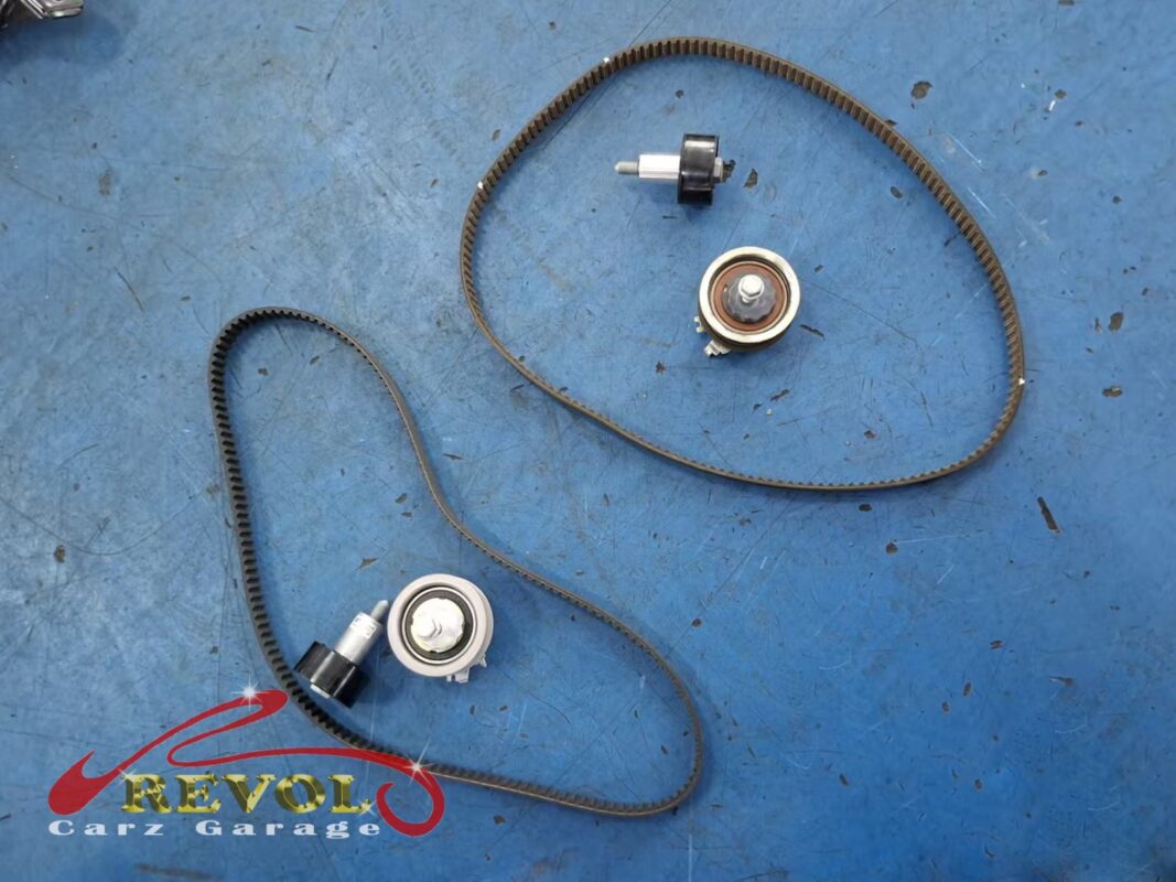 The new VAG-spec timing kit laid out: belts, tensioner and idler pulleys.