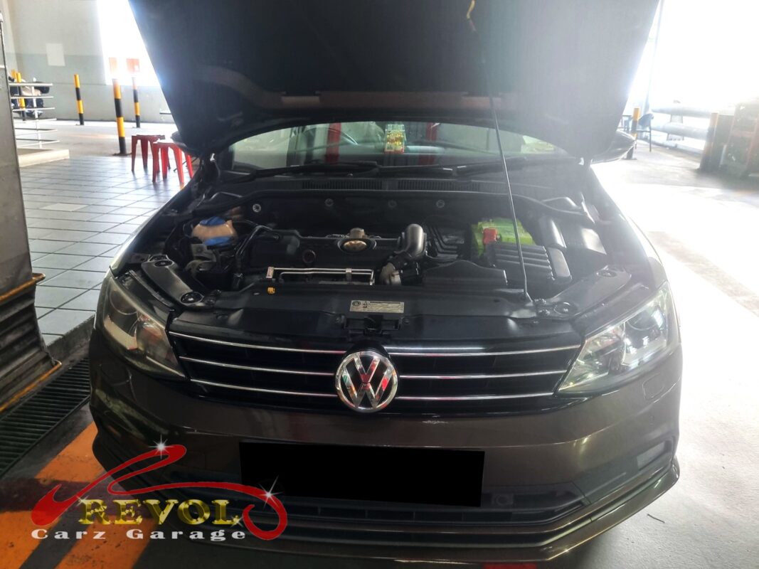 Volkswagen Jetta with the engine cover off for VVT solenoid diagnosis.