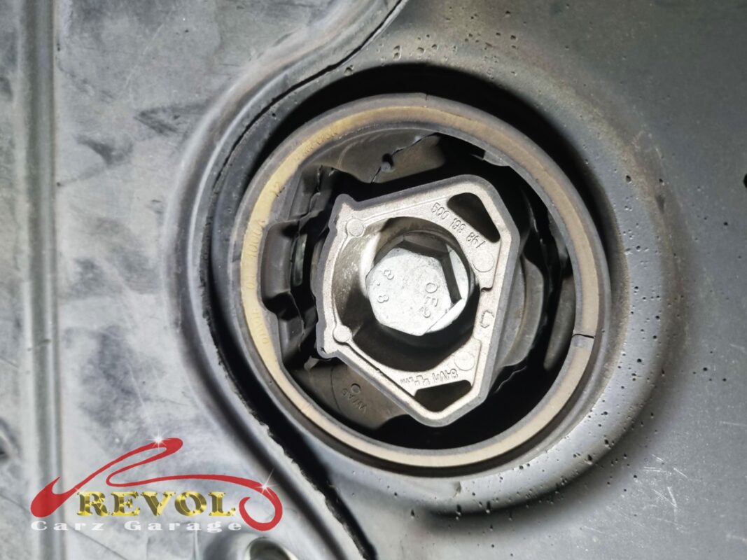 One of the subframe bushings in place, the mounting bolt through the centre.