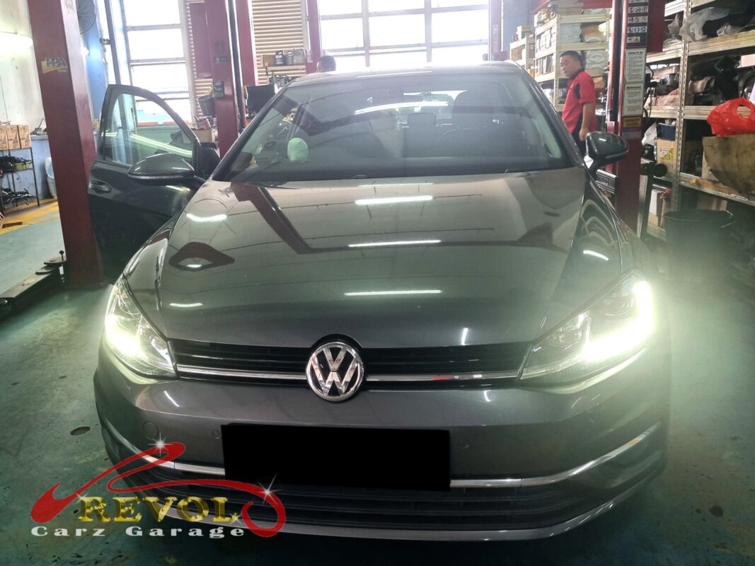 Volkswagen Golf with the engine bay open for oil separator cover replacement.