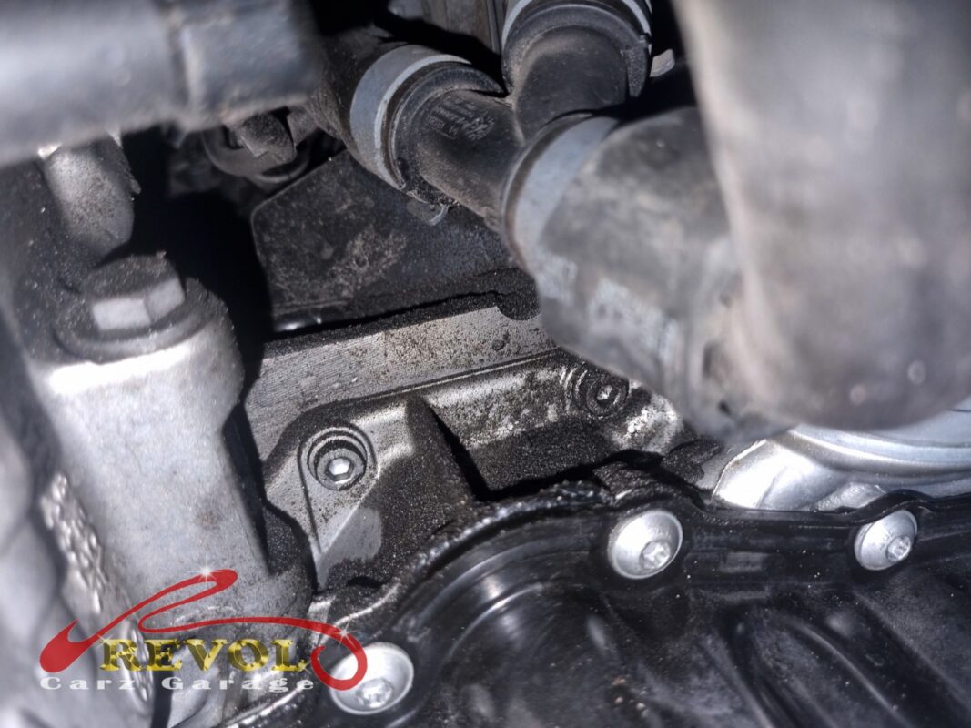 The oil separator area on the side of the engine, oily residue around the seal, before the cover came off.