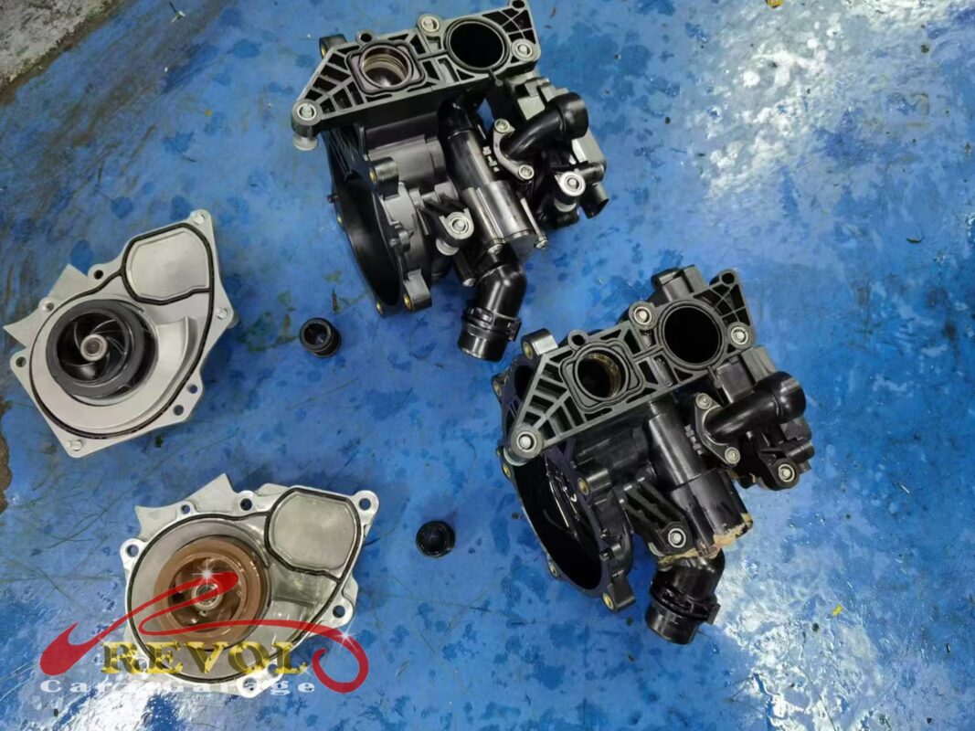 The old water pump and thermostat housing module (left) beside the new VAG-spec assembly (right), pump and housing together.