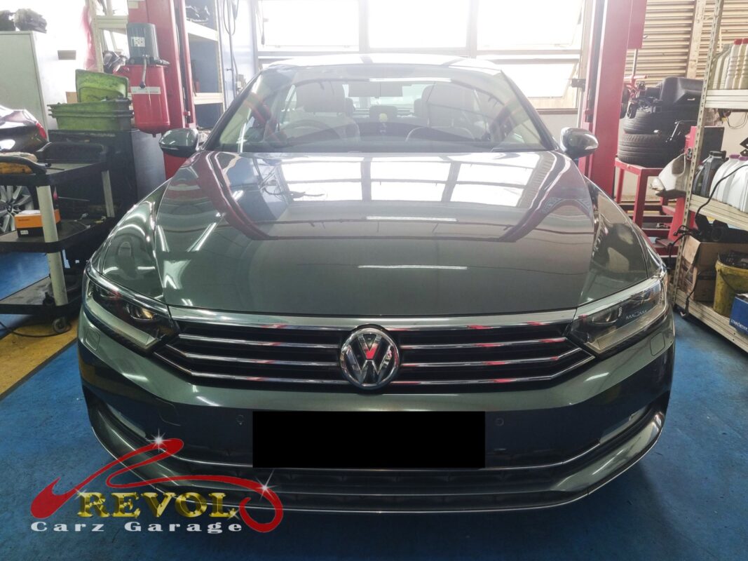 Volkswagen Passat in the workshop with the front wheel off for ABS sensor diagnosis.