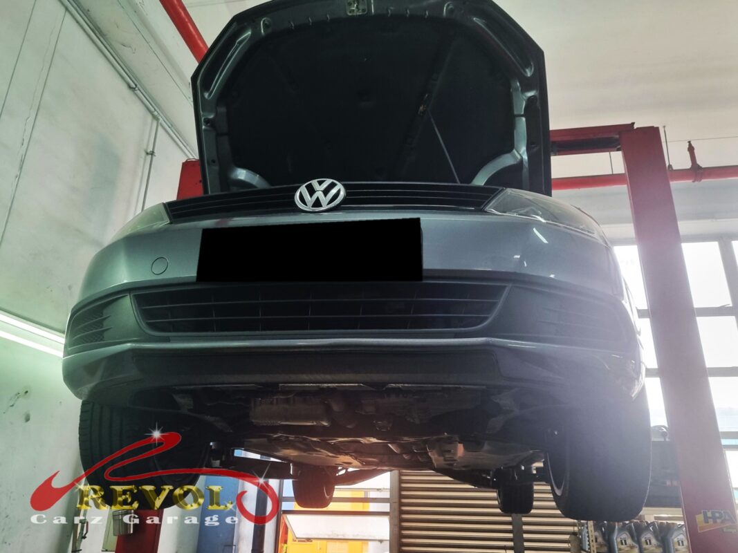 The Jetta up on the two-post lift, bonnet open, in for the belt squeal.
