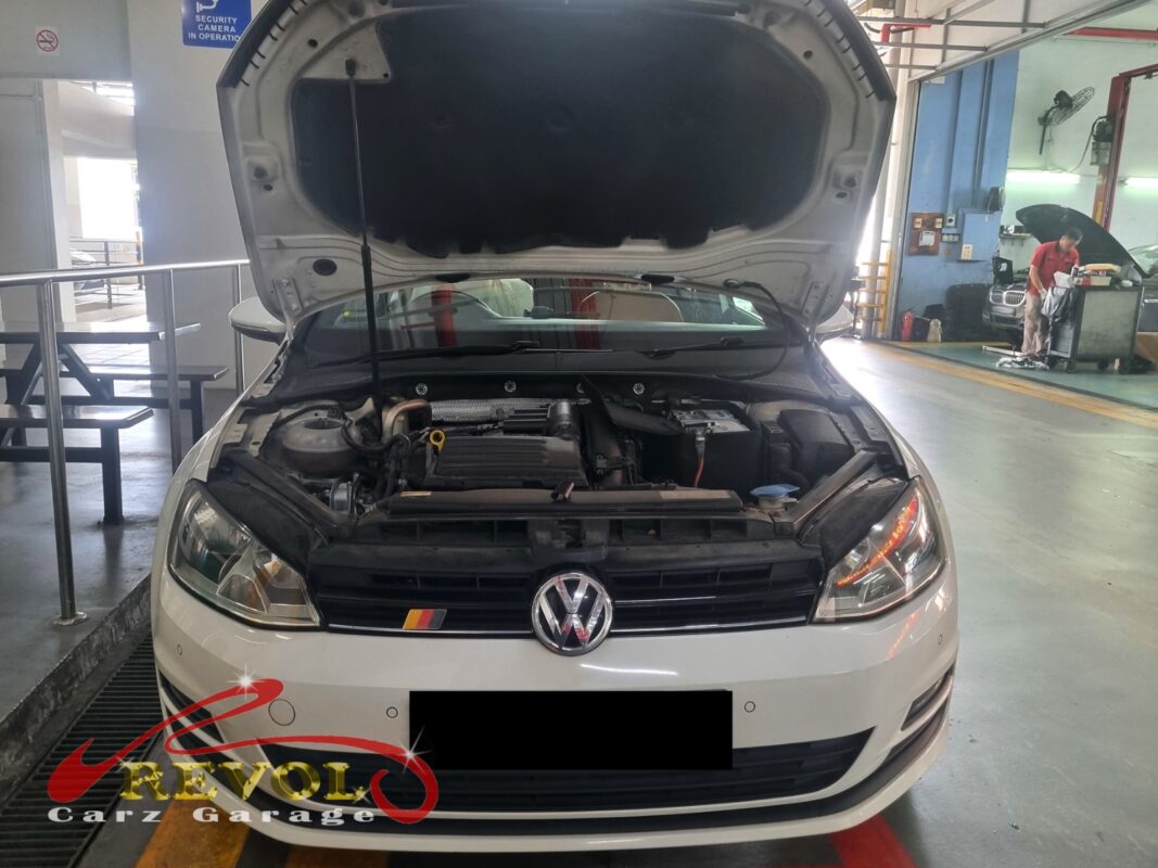 Volkswagen Golf with the engine bay open ready for alternator replacement.