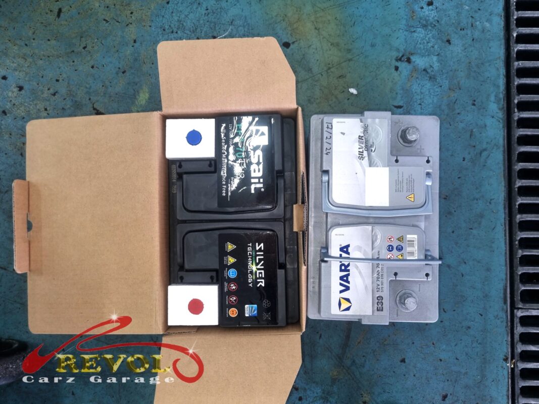 A fresh battery fitted alongside the alternator, the date marked on it.