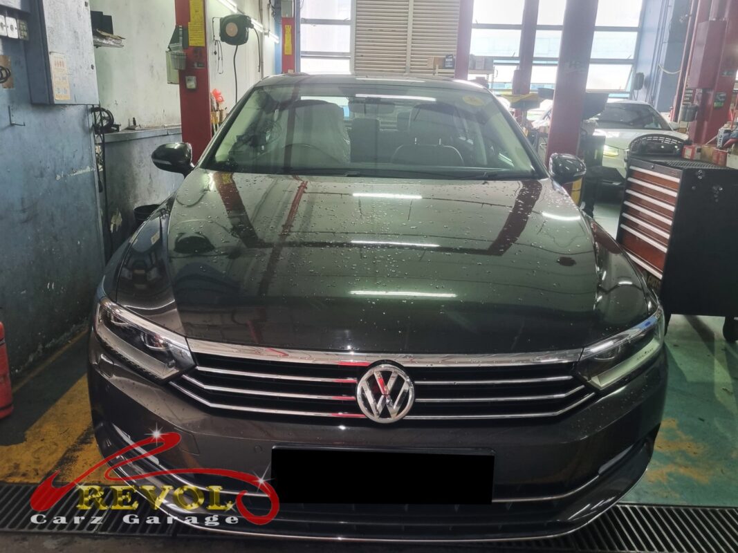 Volkswagen Passat with the front of the engine open for timing pulley cover repair.