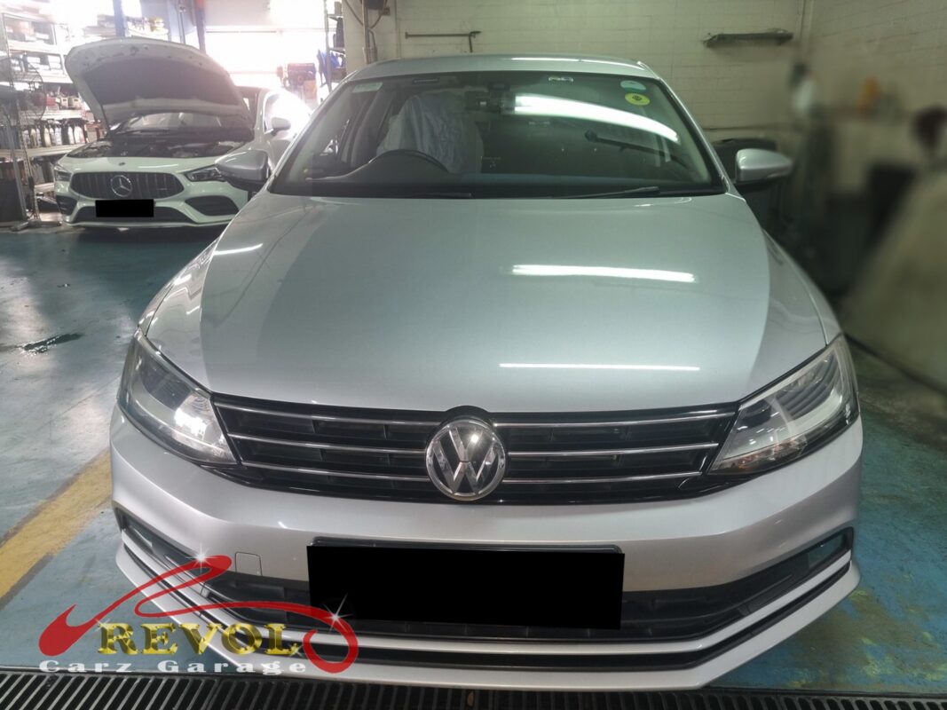 Volkswagen Golf with the engine bay open for thermostat housing replacement.