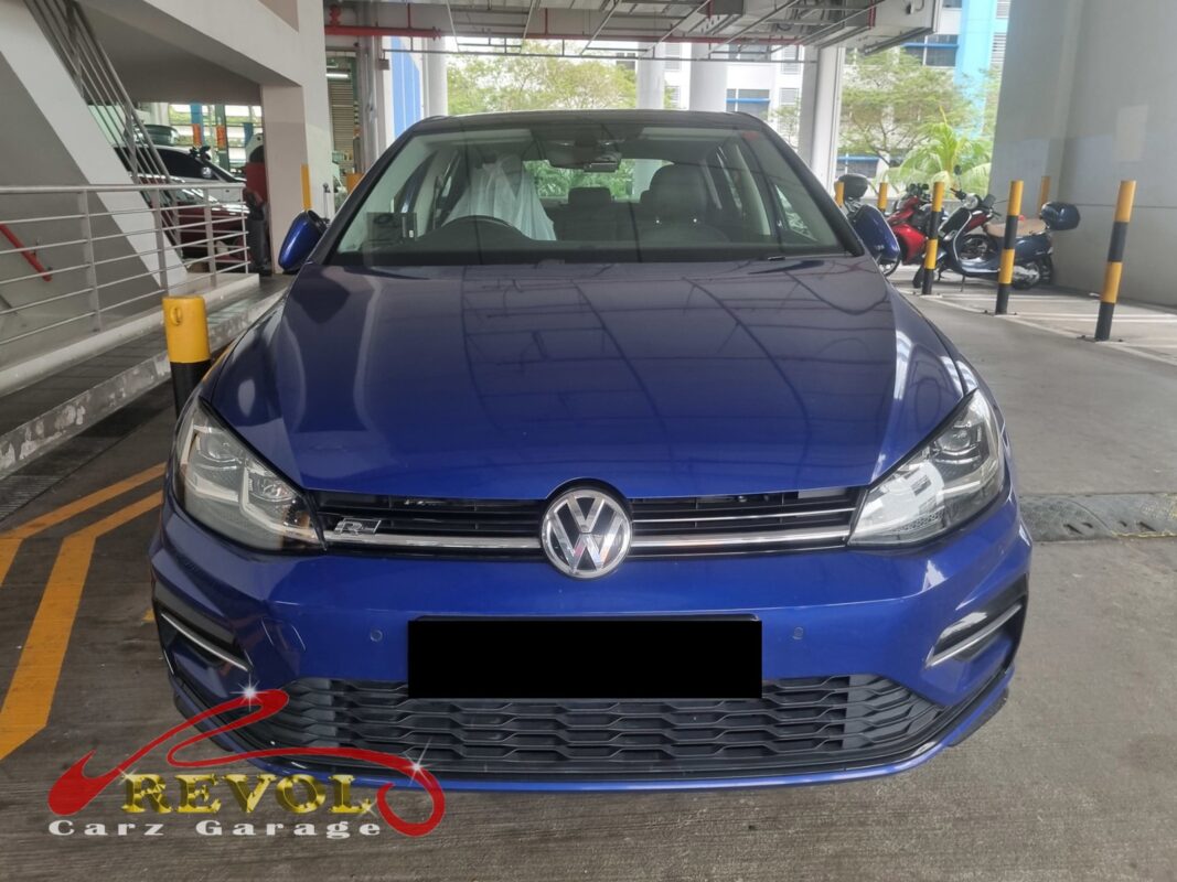 Volkswagen Golf on the workshop lift with front wheels off for brake pad and rotor replacement.