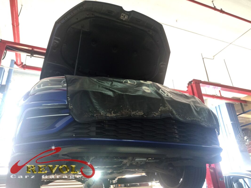 The Golf up on the two-post lift, front covered, in for the brake squeal and pedal vibration.