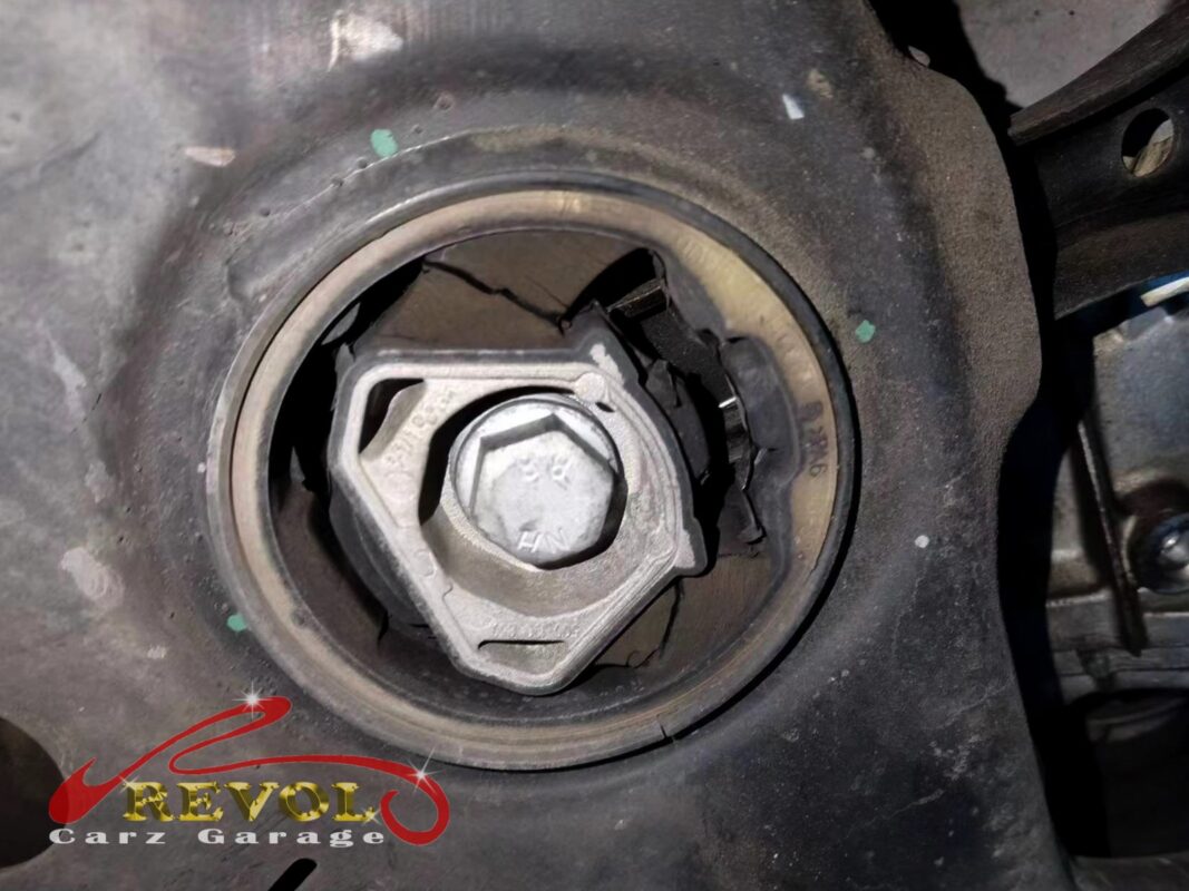 The subframe bush in place, the rubber cracked around the centre, the bolt still in.