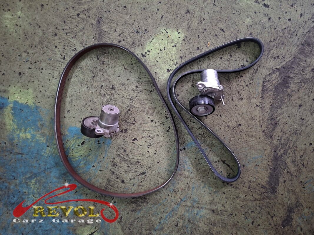 The old accessory belt and tensioner (left) beside the new VAG-spec belt and tensioner (right).