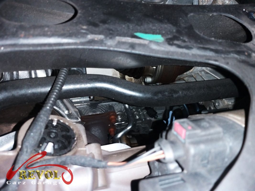 Pressure test on the Volkswagen Golf cooling system finding the weeping water pump and thermostat housing.