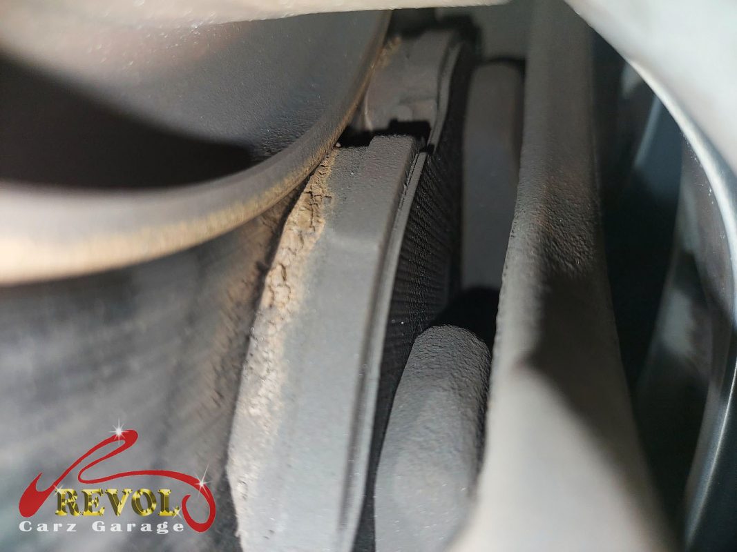 The worn front pads and scored disc on the Volkswagen Passat.