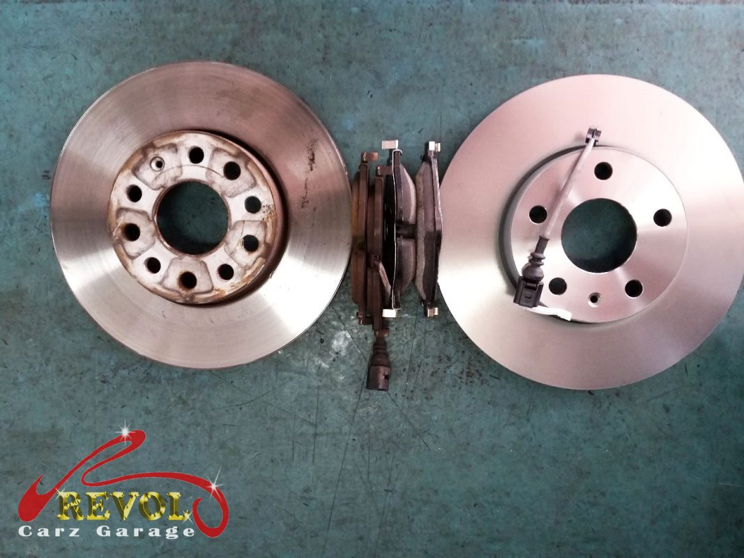 The new front brakes installed and the calipers serviced.