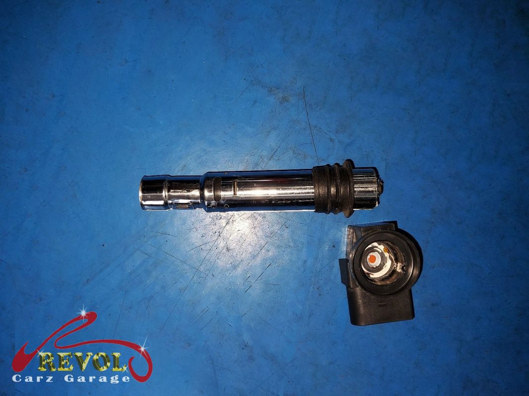 The old ignition coils and worn spark plugs removed.