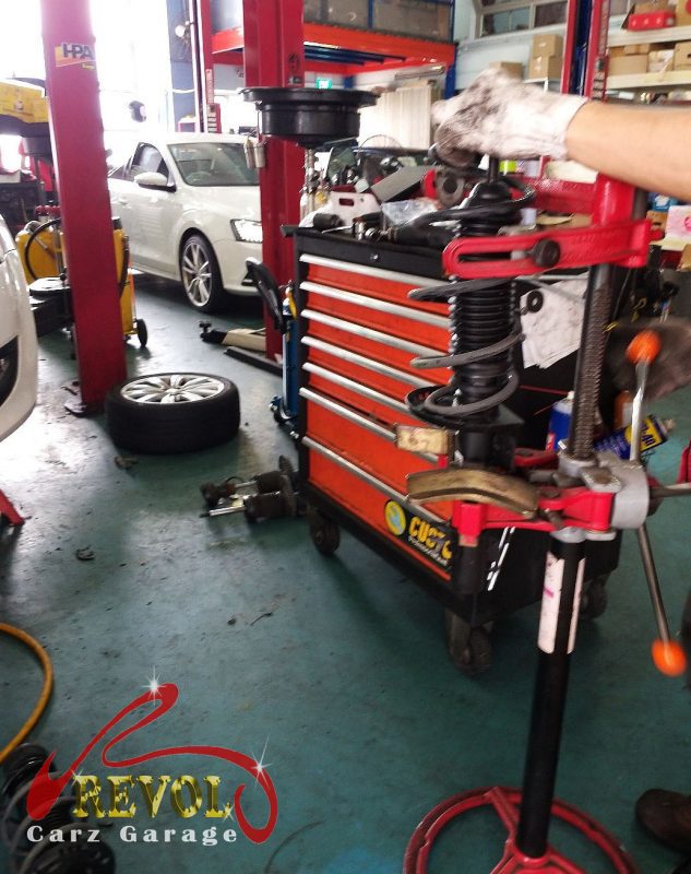 The old front struts removed alongside the new pair.