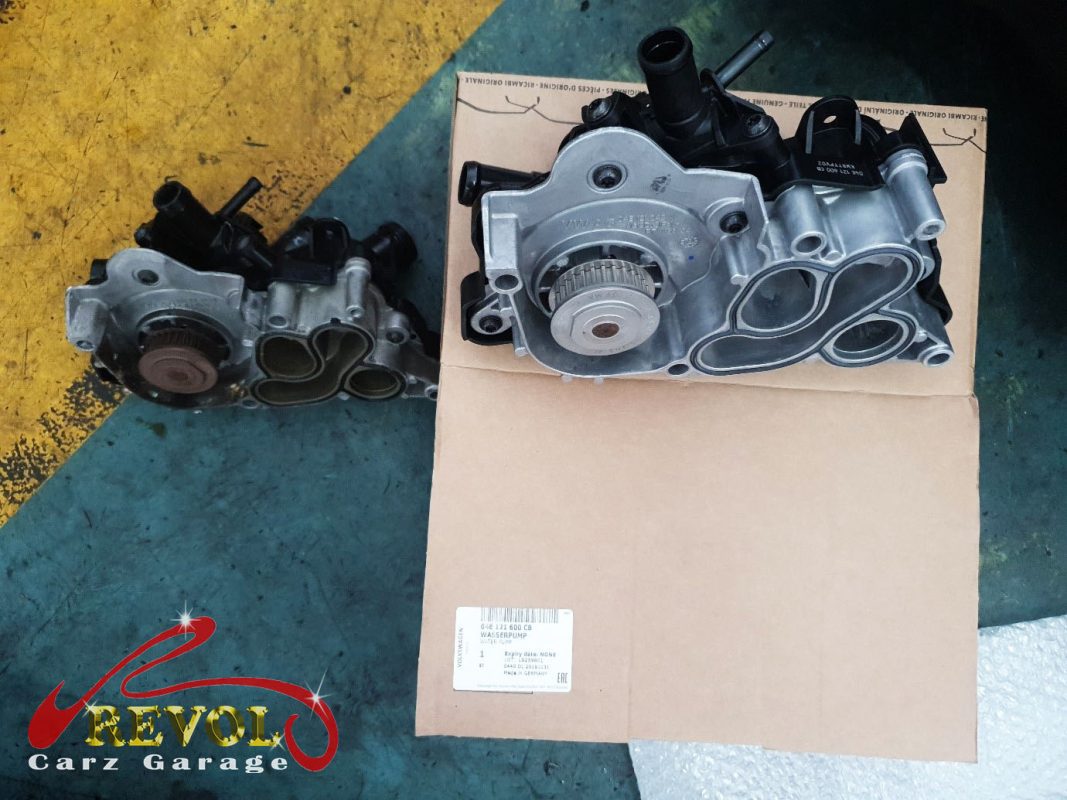 The old coolant pump and thermostat module removed from the engine.