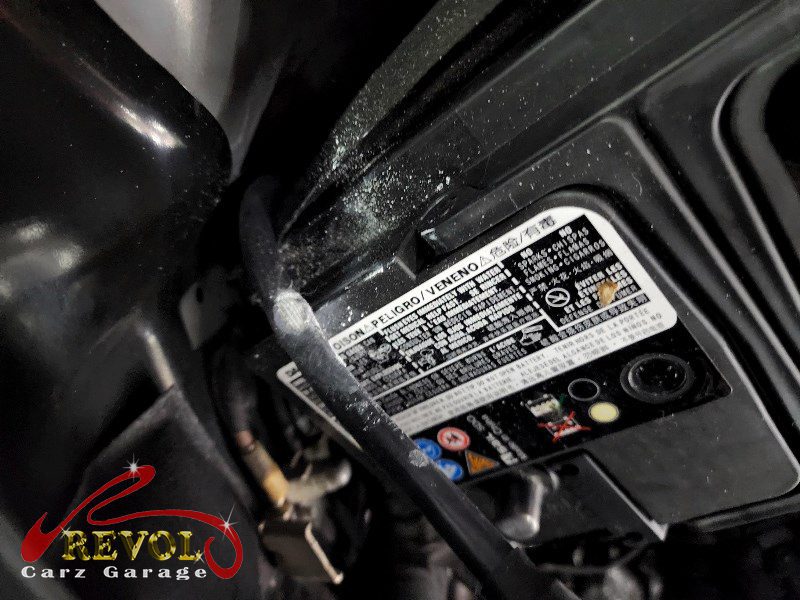 The old corroded battery removed from the Volkswagen Tiguan, the terminals cleaned up.
