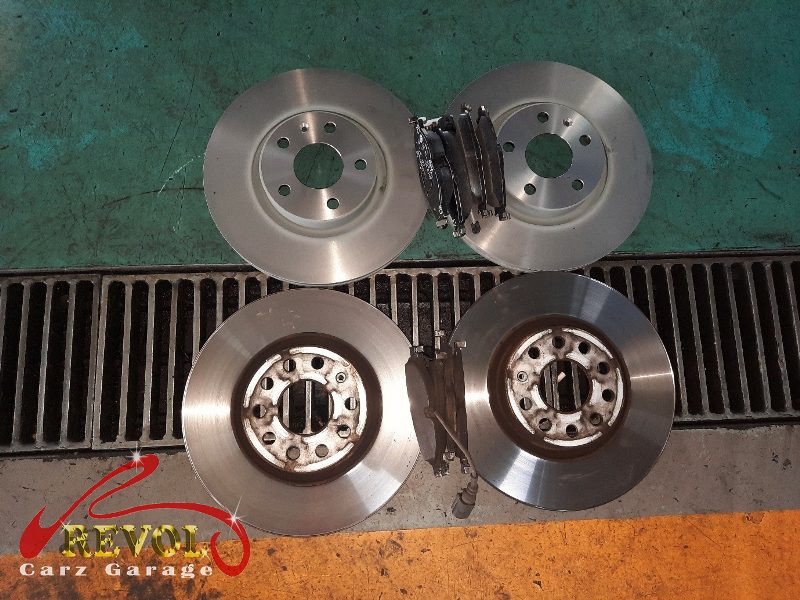 The old front discs removed alongside the new set.