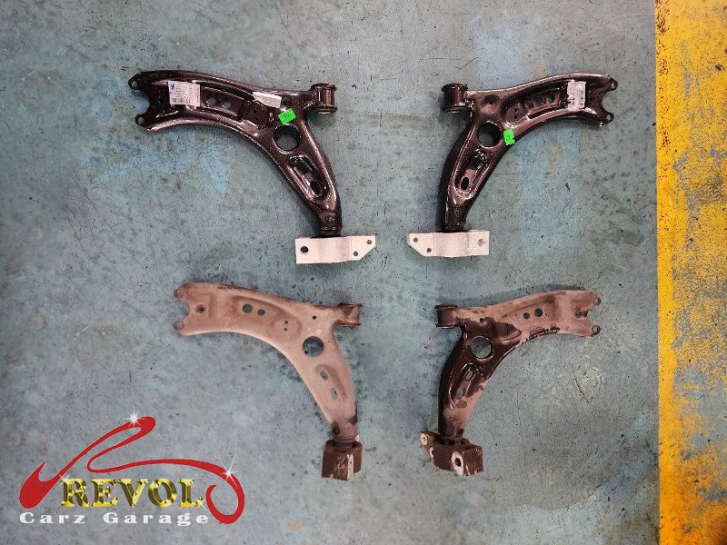 The old control arm and wheel bearing removed from the affected corner.