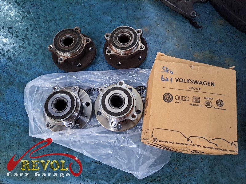 The new genuine VW-spec lower control arm and wheel bearing ready to fit.