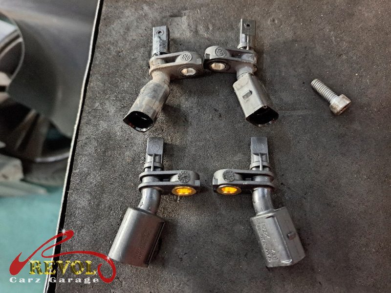 The old front ABS speed sensor removed from the hub.