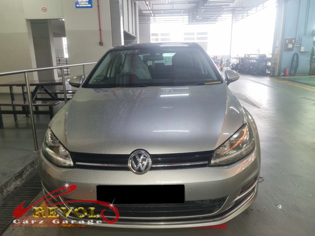 Volkswagen Golf in the workshop with the front wheel off for ABS sensor diagnosis.