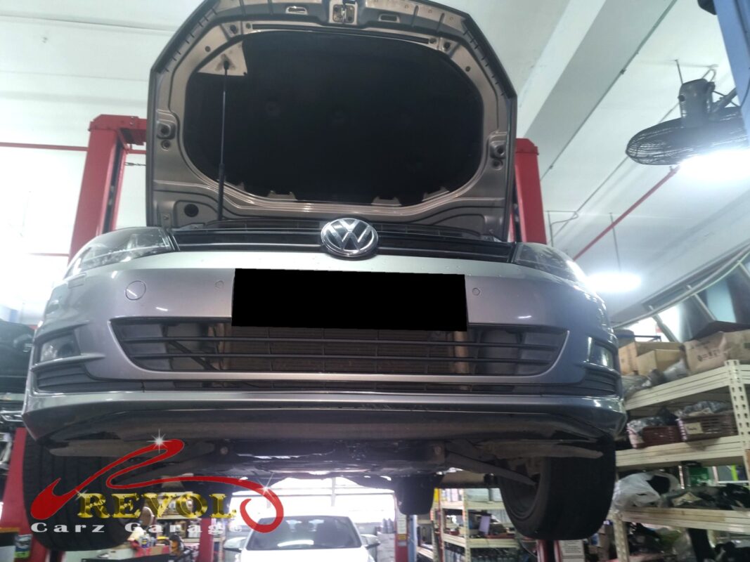 The Golf up on the two-post lift, bonnet open, in for the ABS warning.
