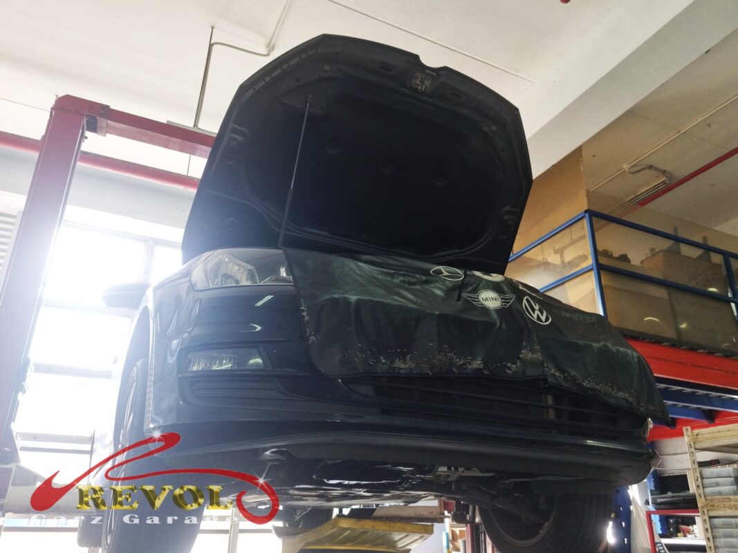 The Golf up on the two-post lift, front covered, in for its full service.