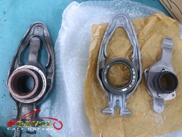 The dismantled gearbox exposing the worn sprockets within.