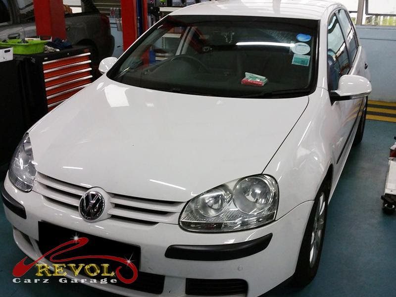 Volkswagen Golf on the ramp at the workshop for an oil change.