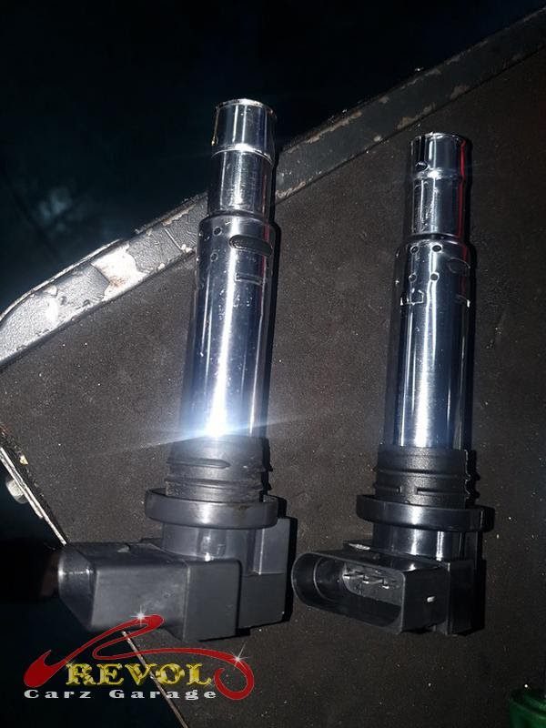 The old ignition coils and worn spark plugs removed.