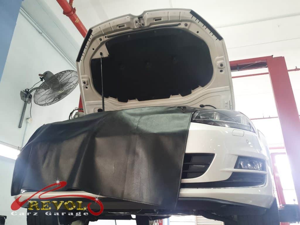The Volkswagen Golf lifted for the 360-degree safety check during the service.
