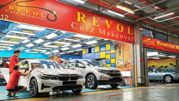 Revol Carz Makeover paint protection centre, BMW and CRV being detailed by team in red