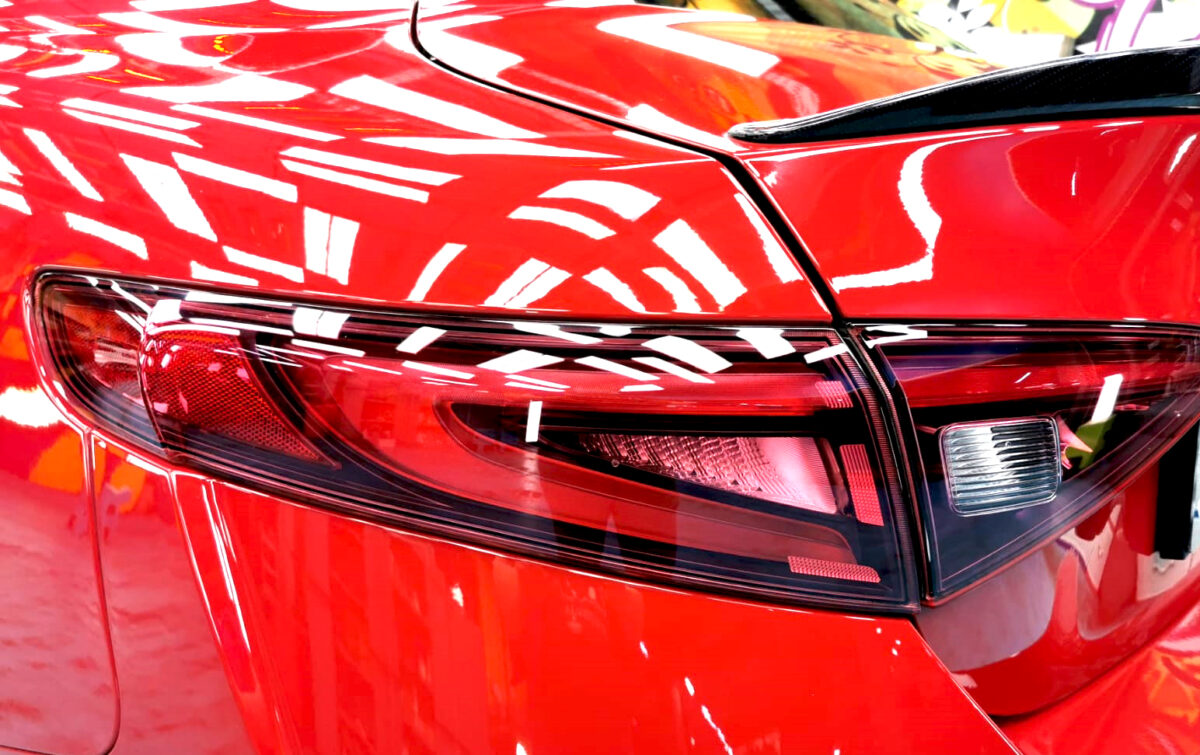The coated bonnet of the Alfa Romeo Giulia under workshop lighting.