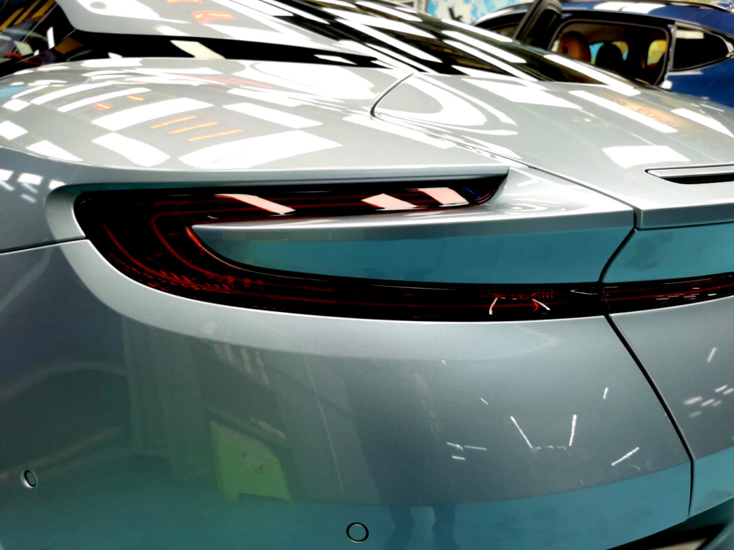 The coated bonnet of the Aston Martin DB11 under workshop lighting.
