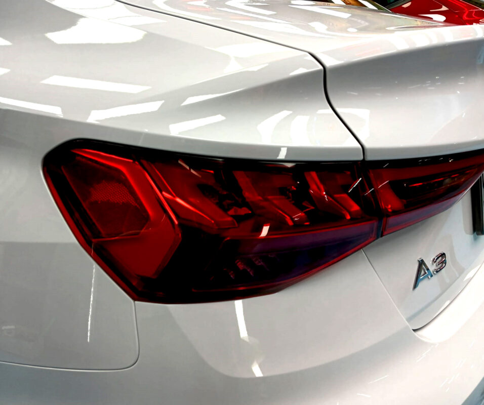 The coated bonnet of the Audi A3 under workshop lighting.