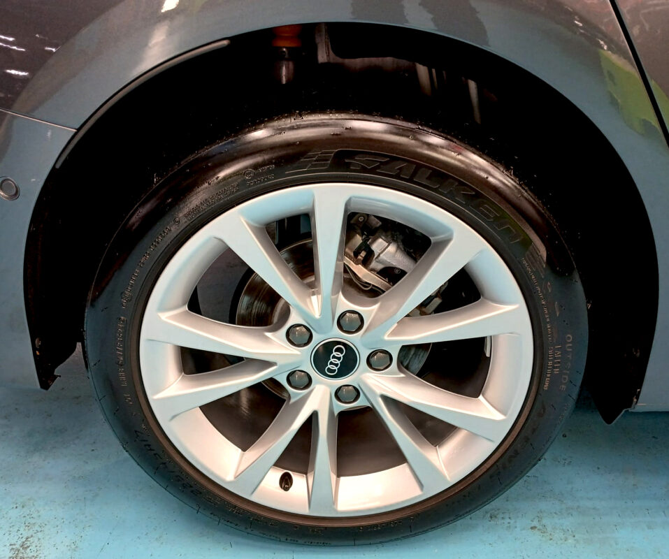 The coated bonnet of the Audi A3 under workshop lighting.