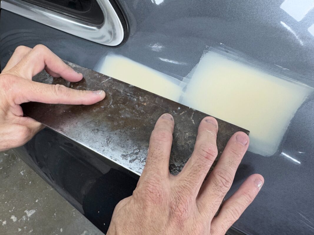 Scratches and dents being repaired and patched on the Audi A3.