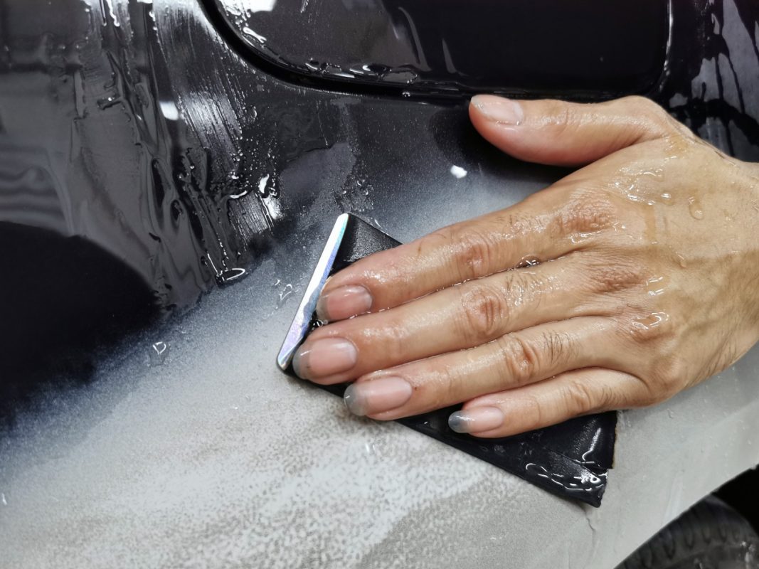 Continuing to wet-sand the body in preparation for spraying.