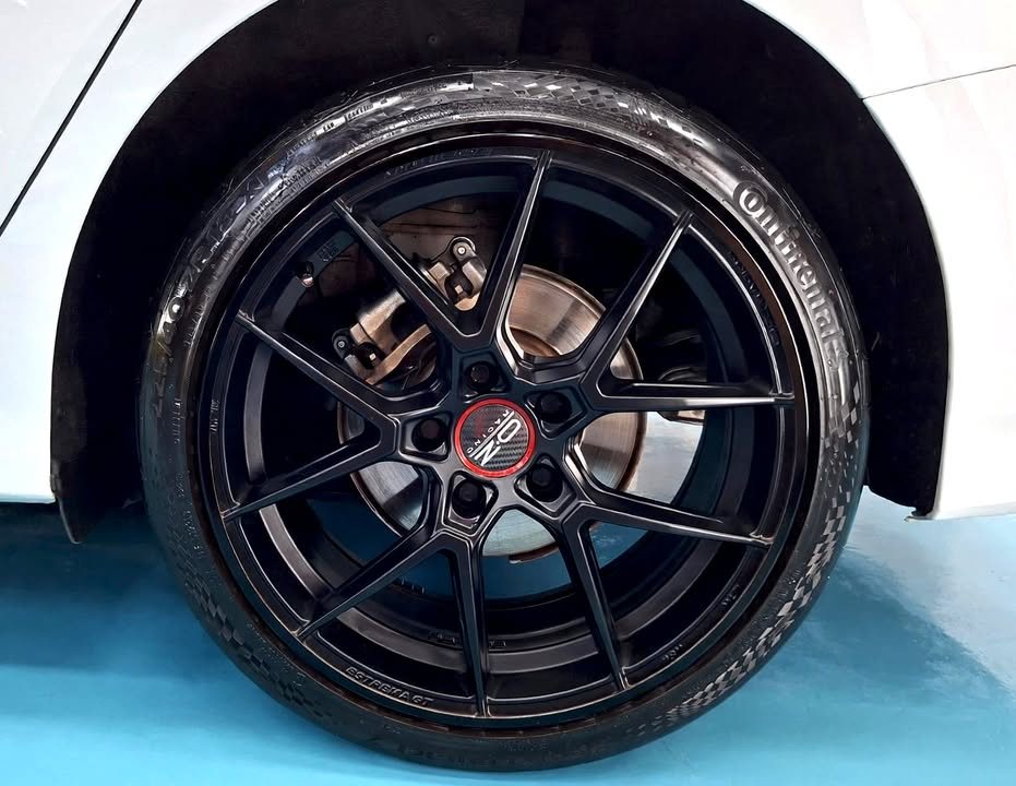 Black multi-spoke alloy wheel on the white Audi A3.