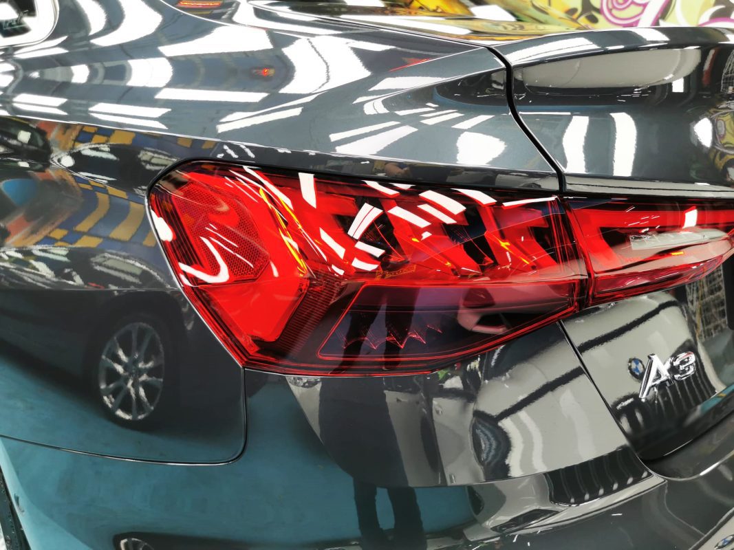 The coated bonnet of the Audi A3 under workshop lighting.