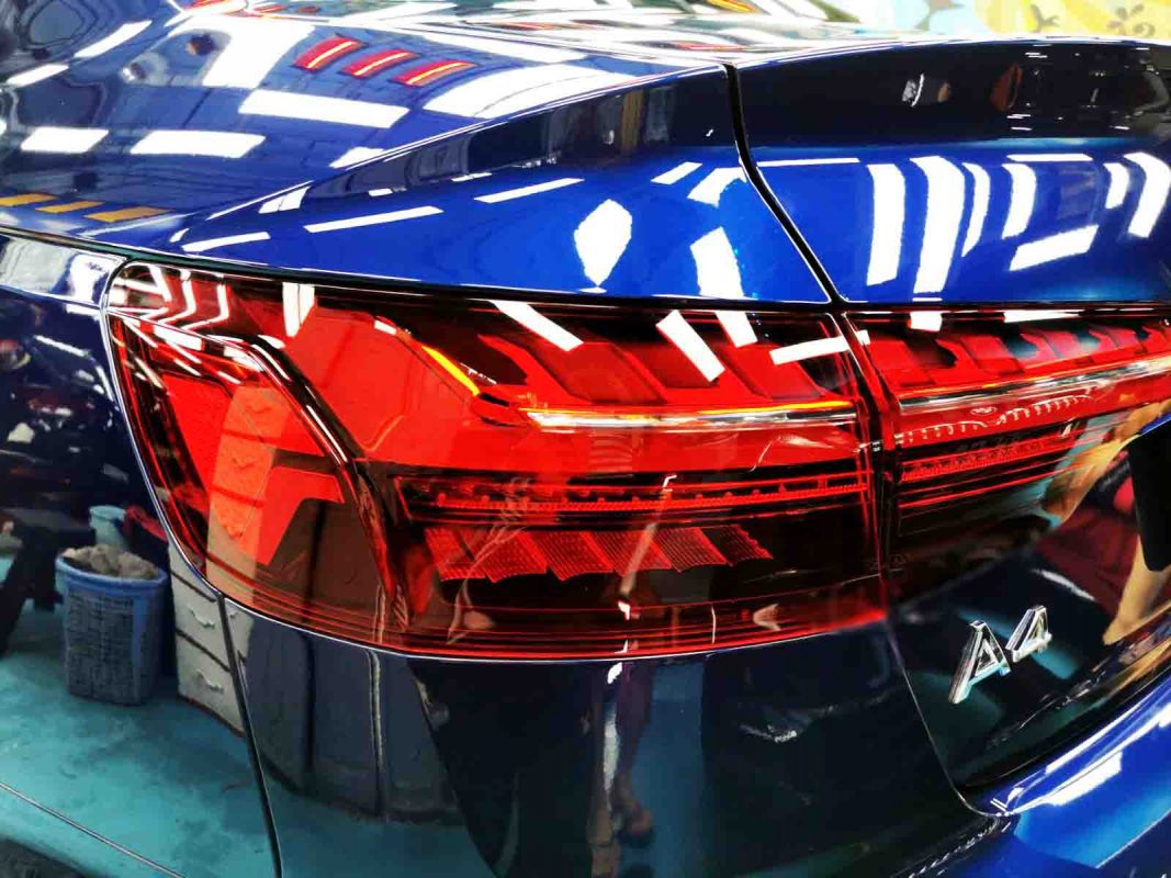 The coated bonnet of the A4 under workshop lighting.