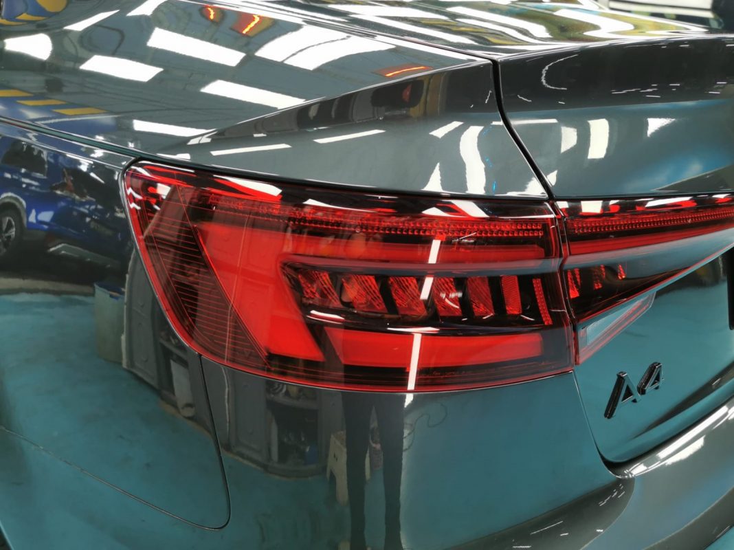 The coated bonnet of the A4 under workshop lighting.